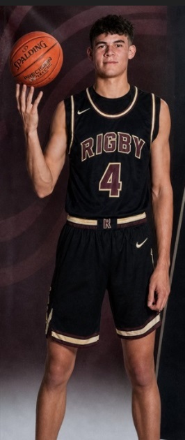 Royce Castle in Rigby basketball uniform holding a basketball